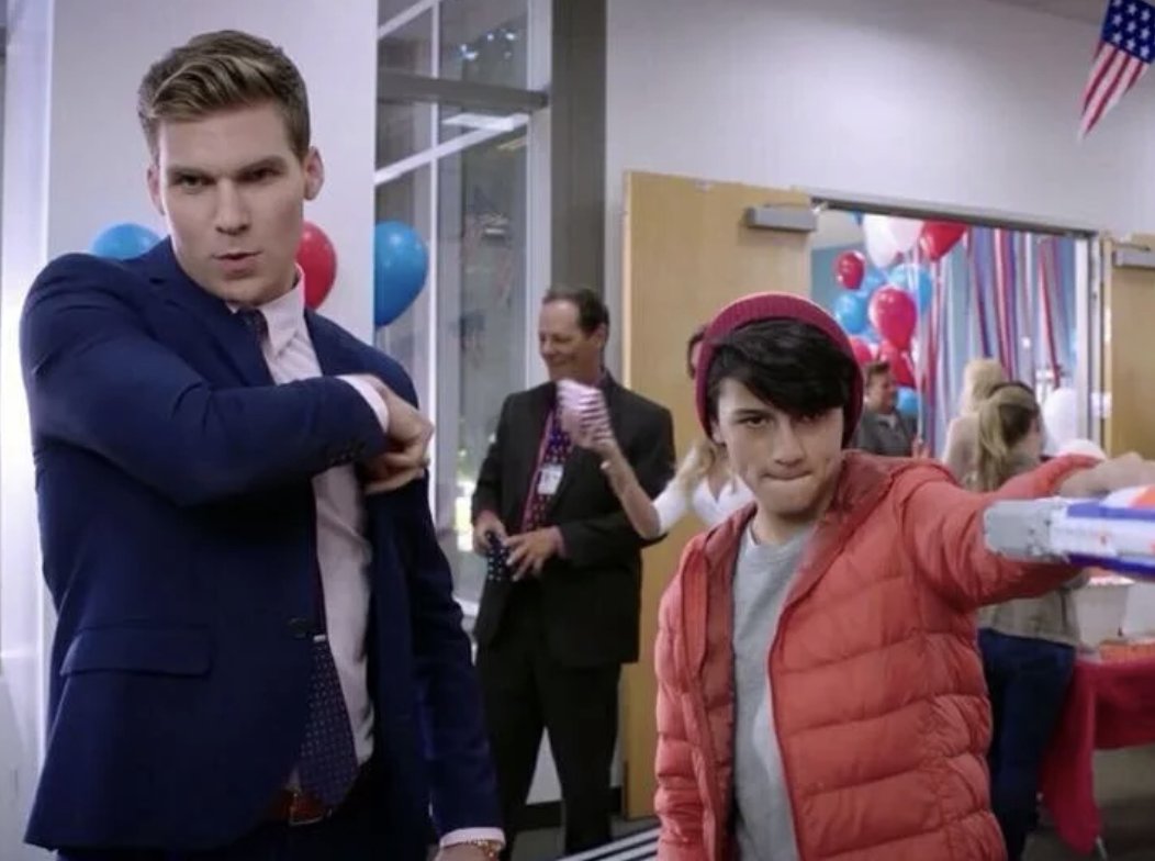 Ethan as a teenager in a red puffer jacket filming a scene